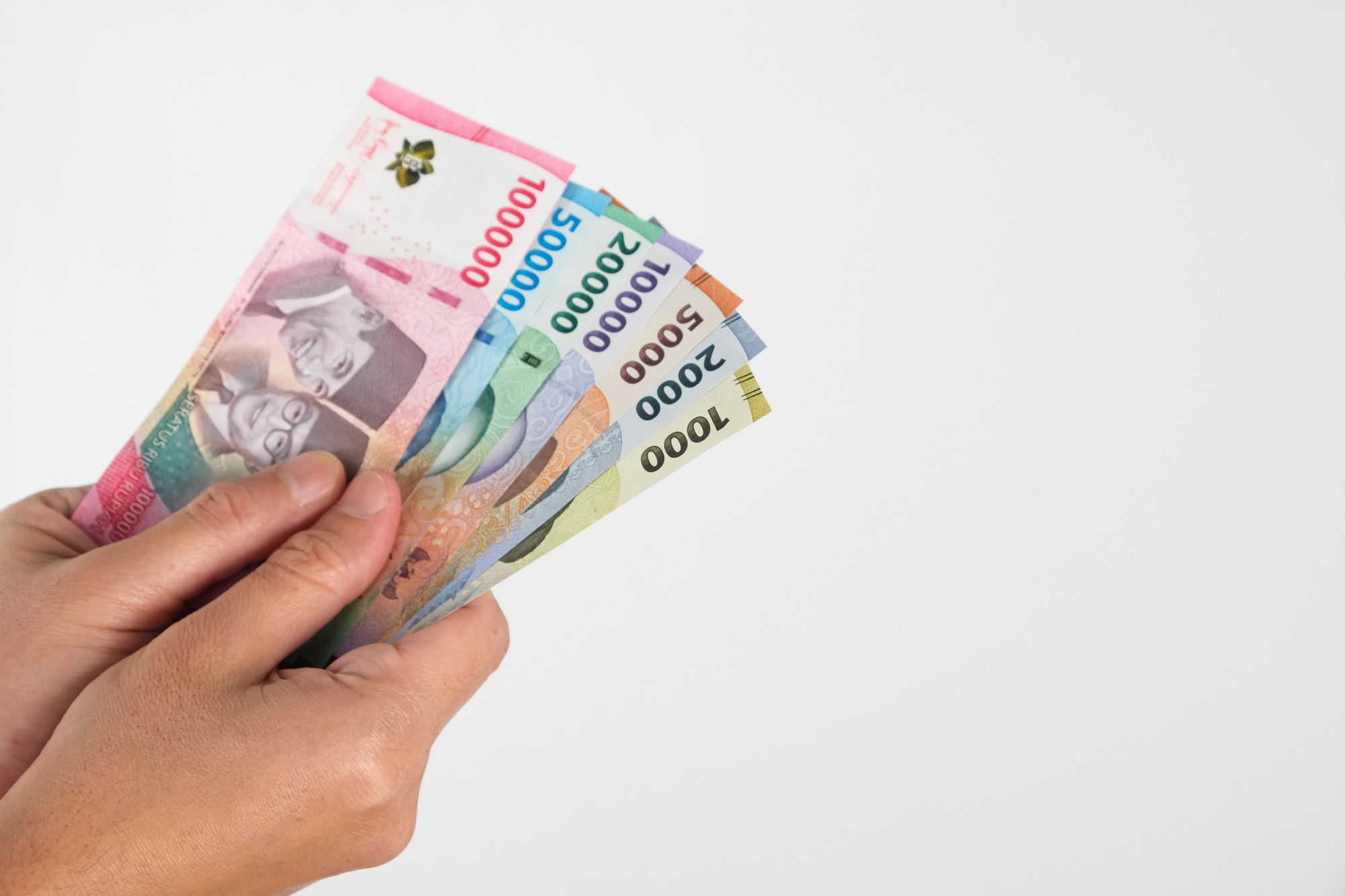 Hand holding rupiah